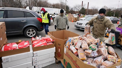Sgt. Kevin Fowler organizes food at a food bank distribution by the Greater Cleveland Food Bank, Cleveland, Jan. 7, 2021.