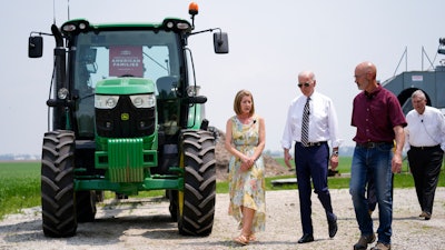 President Joe Biden walks with O'Connor Farms owners Jeff and Gina O'Connor, Kankakee, Ill., May 11, 2022.