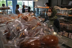 A customer buys bread in a bakery in Tehran, May 11, 2022.
