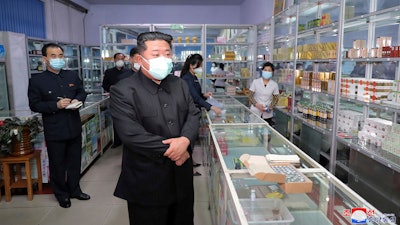 In this photo provided by the North Korean government, North Korean leader Kim Jong Un visits a pharmacy in Pyongyang, May 15, 2022.