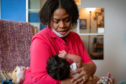 Capri Isidoro of Ellicott City, Md., looks at her one-month-old baby Charlotte, May 23, 2022, Columbia, Md.