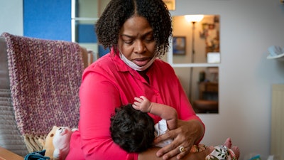 Capri Isidoro of Ellicott City, Md., looks at her one-month-old baby Charlotte, May 23, 2022, Columbia, Md.