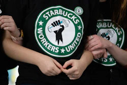 Starbucks employees and supporters react as votes are read during a union-election watch party, Buffalo, N.Y., Dec. 9, 2021.