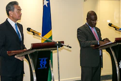 China Foreign Minister Wang Yi, left, and his counterpart from the Solomon Islands, Jeremiah Manele, hold a joint news conference in Honiara, Solomon Islands, May 26, 2022.