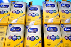 Infant formula is stacked on a table during a baby formula drive to help with the shortage May 14, 2022, in Houston. President Joe Biden has invoked the Defense Production Act to speed production of infant formula and has authorized flights to import supply from overseas.