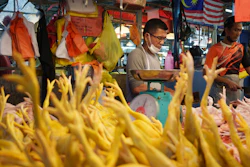 A seller prepares freshly butchered chickens at the Kampung Baru wet market in Kuala Lumpur, May 31, 2022.