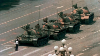 A man blocking a line of tanks on Changan Blvd., Tiananmen Square, Beijing, June 5, 1989.