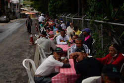 Residents wait for lunch donated by the New Birth's Christian church, Caracas, Venezuela, June 8, 2022.