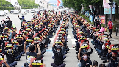 Members of Cargo Truckers Solidarity of the Korean Confederation of Trade Unions shout slogans during a rally in Gwangju, South Korea, June 10, 2022.