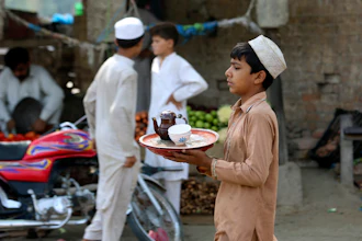 A boy works at a tea shop in Peshawar, Pakistan, June 12, 2022.