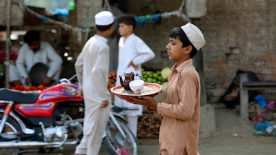 A boy works at a tea shop in Peshawar, Pakistan, June 12, 2022.