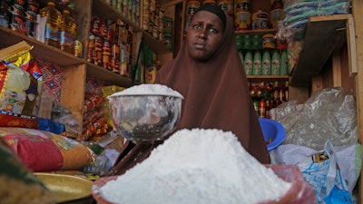 A shopkeeper sells wheat flour in the Hamar-Weyne market in Mogadishu, Somalia, May 26, 2022.