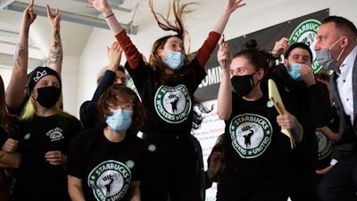 Starbucks employees and supporters react as votes are read during a viewing of their union election, Dec. 9, 2021, Buffalo, N.Y.