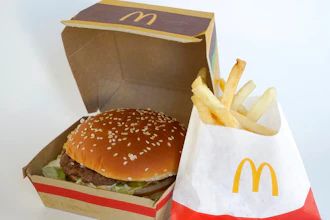 A McDonald's Big Mac, left, rests in a box next to a bag of McDonald's fries, in Walpole, Mass., Wednesday, April 20, 2022. Environmental and health groups are pushing dozens of fast food companies, supermarkets chains and other retail outlets to remove PFAS from their packaging.