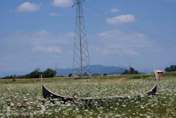 A gondola used as a bench lies on a field in Cornate D'Adda, Italy, July 13, 2022.