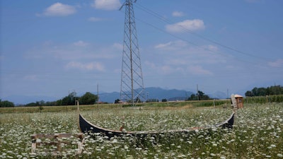 A gondola used as a bench lies on a field in Cornate D'Adda, Italy, July 13, 2022.