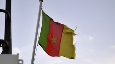 A Cameroonian flag flies on a ship at the port in Douala, Cameroon, April 10, 2022.
