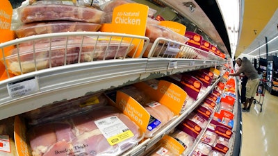 Chicken is on display in a market in Pittsburgh, July 12, 2022. The Justice Department is expected to file a lawsuit and proposed settlement against some of the largest poultry producers in the U.S. It's part of an effort to end what the government claims have been longstanding deceptive and abusive practices for workers.