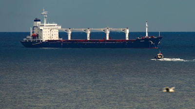 A boat with Russian, Ukrainian, Turkish and U.N. officials heads to the Sierra Leone-flagged cargo ship Razoni off the coast of Istanbul, Aug. 3, 2022.