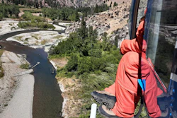 Fisheries biologist Eli Felts looking down at Loon Creek to count chinook salmon spawning beds in the Frank Church River of No Return Wilderness, Idaho, Sept. 9, 2020.