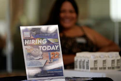 A sign placed at a booth during a job fair in West Hollywood, Los Angeles, Sept. 22, 2021.