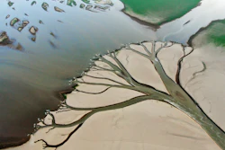 Water flows through channels in the lake bed of Poyang Lake, Aug. 22, 2022.