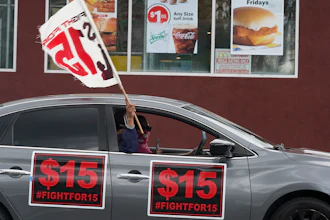 Fast food workers drive though a McDonald's restaurant demanding a $15 hourly minimum wage, East Los Angeles, Calif., March 12, 2021.