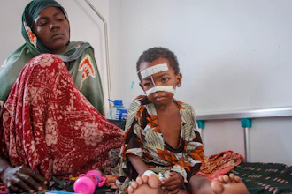 Kalson Hussein, 4, sits next to her mother, Isho Shukria, 35, at the Martini hospital, Mogadishu, Sept. 3, 2022.