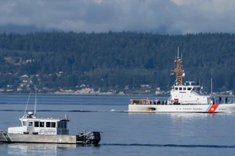 A U.S. Coast Guard boat and a Kitsap Co. Sheriff's Dept. boat search the area near Freeland, Wash., Sept. 5, 2022.