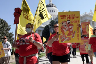 Fast food workers and supporters march past the California state Capitol, Sacramento, Aug. 16, 2022.
