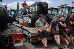 Protesting farmers talk at a blockade outside an Aldi distribution center, Drachten, Netherlands, July 4, 2022.