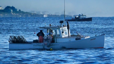 Lobstermen work off the coast of Kennebunkport, Maine, Sept. 8, 2022.