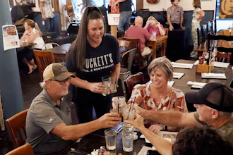 Macy Norman, center, serves a table of guests at Puckett's Grocery and Restaurant, Sept. 10, 2021, Nashville.