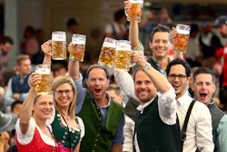 Visitors lift glasses of beer during the opening of the 186th Oktoberfest beer festival in Munich, Sept. 21, 2019.