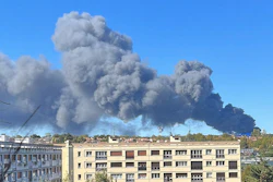 Smoke rises from a warehouse blaze at a produce market in Paris' southern suburbs, Sept. 25, 2022.