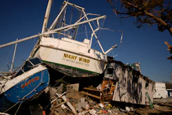 Damaged shrimp boats and debris litter the waterfront at Erickson & Jensen Seafood, San Carlos Island, Fort Myers Beach, Fla., Oct. 7, 2022.