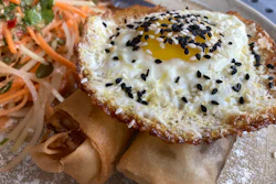 A vegan chorizo egg roll and a meat chorizo egg roll topped with a fried egg and a papaya and carrot slaw, BOCA restaurant, Tucson, Ariz., Oct. 14, 2022.