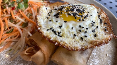A vegan chorizo egg roll and a meat chorizo egg roll topped with a fried egg and a papaya and carrot slaw, BOCA restaurant, Tucson, Ariz., Oct. 14, 2022.