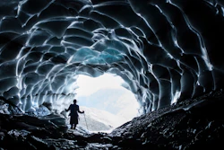 A man stands in a cave at the Sardona glacier, July 27, 2022, Vaettis, Switzerland.