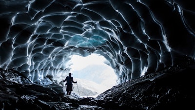 A man stands in a cave at the Sardona glacier, July 27, 2022, Vaettis, Switzerland.