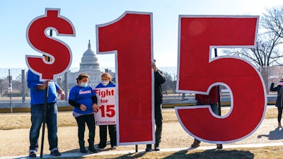 Activists appeal for a $15 minimum wage near the Capitol in Washington, Thursday, Feb. 25, 2021. According to the Economic Policy Institute, the federal minimum wage in 2021 was worth 34% less than in 1968, when its purchasing power peaked.