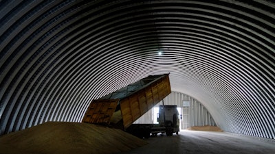 A dump track unloads grain, Zghurivka, Ukraine, Aug. 9, 2022.