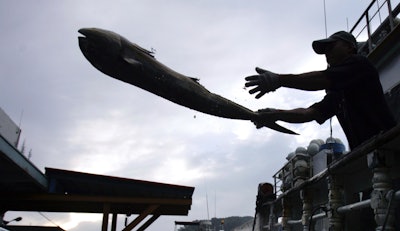 A fisherman unloads his catch in the port of Suao, Taiwan, June 21, 2015.