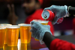 A staff member pours a beer at a fan zone ahead of the FIFA World Cup, Doha, Qatar, Nov. 19, 2022.
