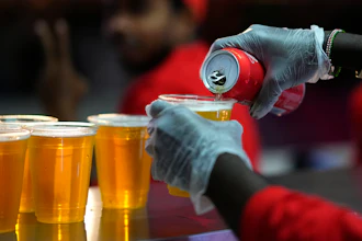 A staff member pours a beer at a fan zone ahead of the FIFA World Cup, Doha, Qatar, Nov. 19, 2022.
