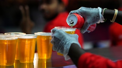 A staff member pours a beer at a fan zone ahead of the FIFA World Cup, Doha, Qatar, Nov. 19, 2022.