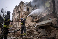 Ukrainian State Emergency Service firefighters work to extinguish a fire at the building which was destroyed by a Russian attack in Kryvyi Rih, Dec. 16, 2022.