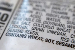 A notification for sesame is printed under the ingredient list on a bag of hot dog buns in New York on Wednesday, Dec. 21, 2022. A new federal law requiring that sesame be listed as an allergen on food labels is having unintended consequences _ increasing the number of products that include the ingredient. Starting Jan. 1, all foods made and sold in the U.S. must be labeled if they contain sesame, an often-hidden ingredient that's been declared the nation's ninth major allergen.