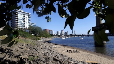 A section of newly formed beach is shown on the Willamette River in downtown Portland, Ore., on July 6, 2017. Monsanto has agreed to pay Oregon a lump sum of $698 million for its role in polluting the state with PCBs over a 90-year period until they were banned in 1977. Oregon Attorney General Ellen Rosenblum said Thursday, Dec. 15, 2022, that the settlement amount is the largest environmental damage recovery in Oregon's history.