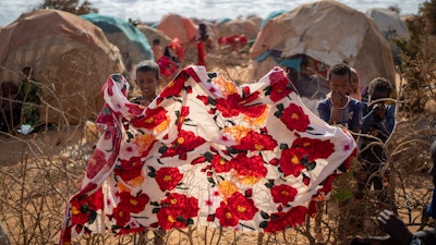 Children stand near shelters at a camp for displaced people on the outskirts of Dollow, Somalia, Sept. 19, 2022.